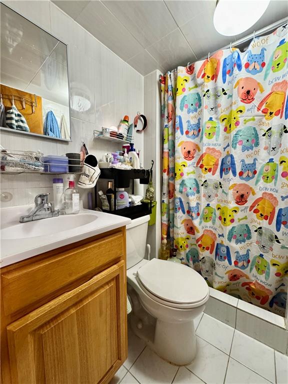 1414 76th St, Brooklyn, NY 11228 - bathroom featuring vanity, tile patterned floors, toilet, curtained shower, and backsplash