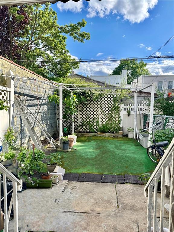 1414 76th St, Brooklyn, NY 11228 - fenced backyard with a patio area
