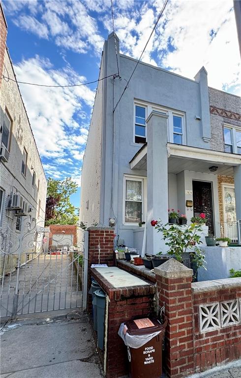1414 76th St, Brooklyn, NY 11228 - view of side of property featuring a gate and stucco siding