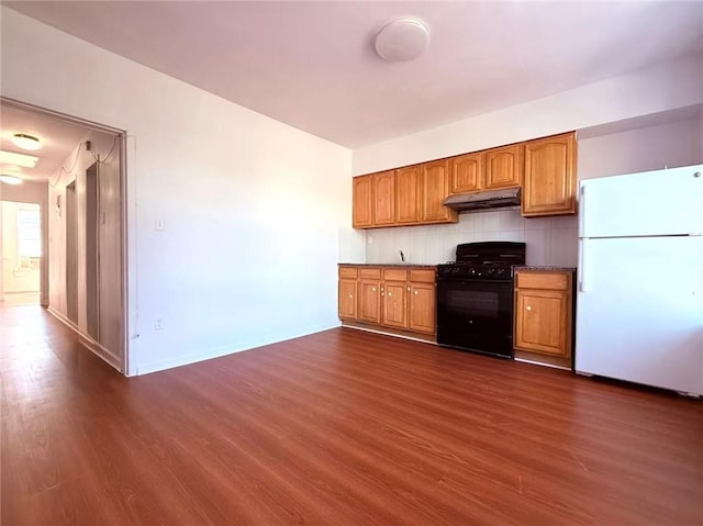 1414 76th St, Brooklyn, NY 11228 - kitchen featuring freestanding refrigerator, black range with gas cooktop, under cabinet range hood, and dark wood finished floors