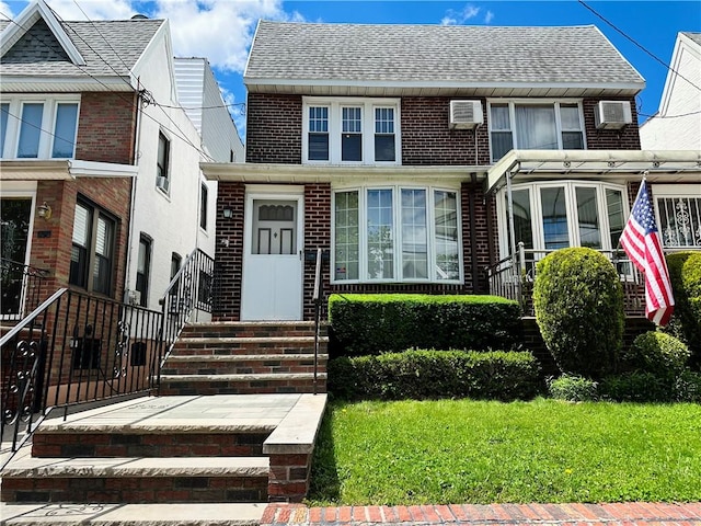 974 77th St, Brooklyn, NY 11228 - view of front facade featuring entry steps, brick siding, a front lawn, and a shingled roof