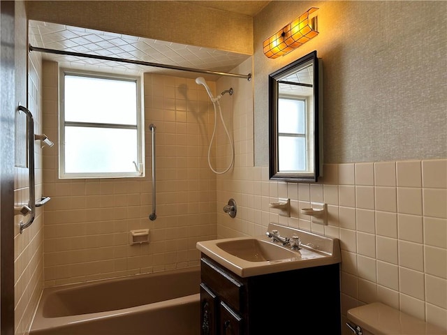 974 77th St, Brooklyn, NY 11228 - full bathroom with vanity, tub / shower combination, tile walls, toilet, and wainscoting