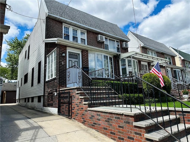 974 77th St, Brooklyn, NY 11228 - view of front of property with a shingled roof, a fenced front yard, and brick siding