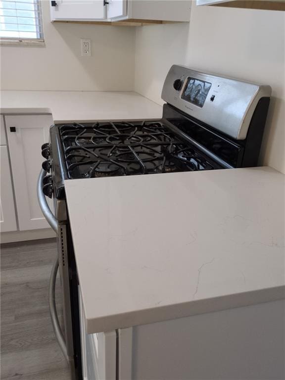 7 Georgetown Ln, Brooklyn, NY 11234 - kitchen with gas stove, white cabinets, and wood finished floors