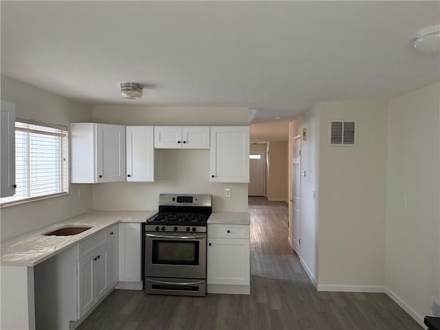 7 Georgetown Ln, Brooklyn, NY 11234 - kitchen with stainless steel range with gas cooktop, white cabinetry, and light countertops