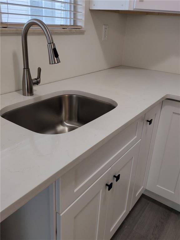 7 Georgetown Ln, Brooklyn, NY 11234 - kitchen view of a sink, white cabinets, and dark wood-style flooring
