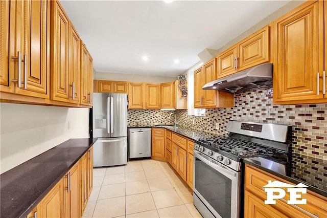 2077 Hendrickson St, Brooklyn, NY 11234 - kitchen with stainless steel appliances, under cabinet range hood, a sink, light tile patterned floors, and backsplash