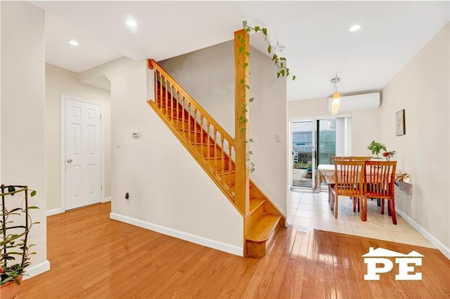 2077 Hendrickson St, Brooklyn, NY 11234 - stairway featuring hardwood / wood-style flooring, baseboards, an AC wall unit, and recessed lighting