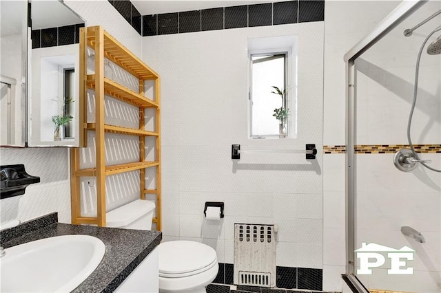 2077 Hendrickson St, Brooklyn, NY 11234 - bathroom with radiator heating unit, a shower stall, toilet, tile walls, and vanity