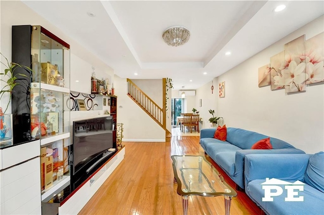 2077 Hendrickson St, Brooklyn, NY 11234 - living room featuring wood finished floors, a raised ceiling, stairs, recessed lighting, and baseboards