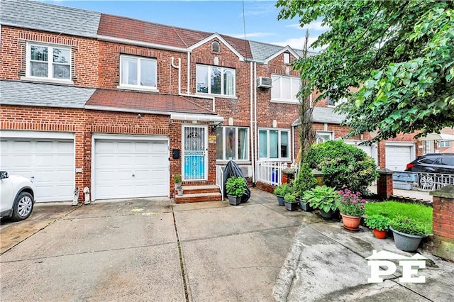 2077 Hendrickson St, Brooklyn, NY 11234 - view of property featuring driveway, brick siding, roof with shingles, and an attached garage