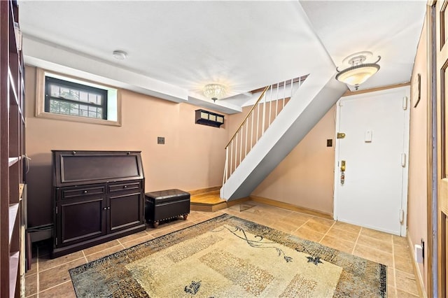 680 81st St Unit 1B, Brooklyn, NY 11228 - foyer entrance featuring stairs, light tile patterned floors, and baseboards