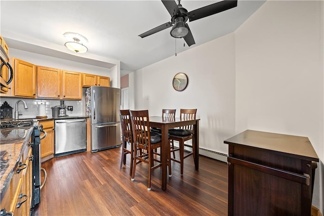 680 81st St Unit 1B, Brooklyn, NY 11228 - kitchen with stainless steel appliances, dark wood-style flooring, a ceiling fan, and backsplash