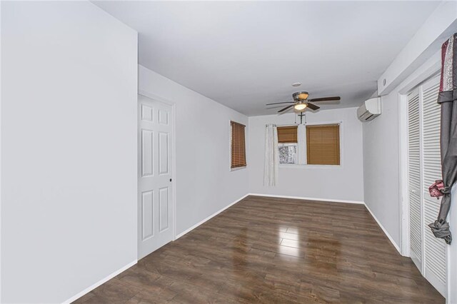 47 Center Pl, Staten Island, NY 10306 - unfurnished room with a wall unit AC, a ceiling fan, wood finished floors, and baseboards