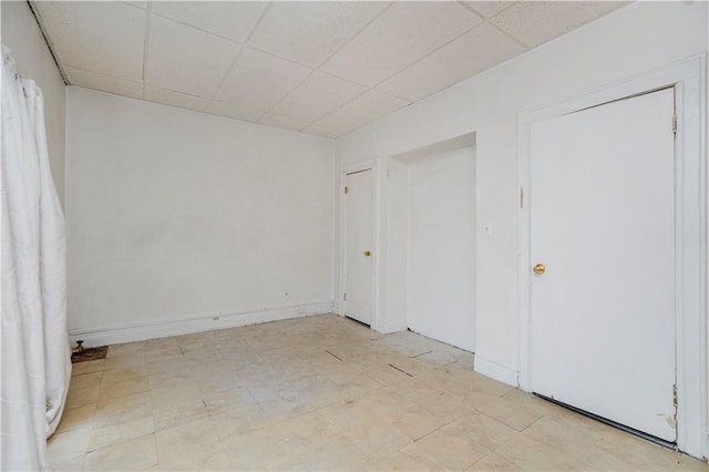 2424 W 3rd St, Brooklyn, NY 11223 - unfurnished bedroom featuring tile patterned floors and a paneled ceiling