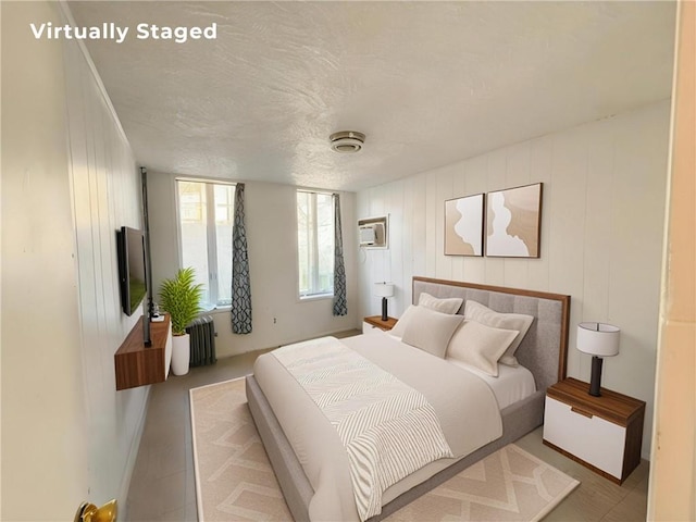 1685 E 2nd St, Brooklyn, NY 11223 - bedroom with radiator, a wall mounted AC, and a textured ceiling