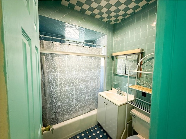 1685 E 2nd St, Brooklyn, NY 11223 - bathroom featuring tile walls, toilet, vanity, and shower / bathtub combination with curtain