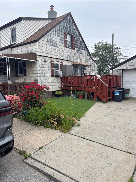 37 Celeste Ct, Brooklyn, NY 11229 - view of side of property featuring a chimney, a wooden deck, a shingled roof, and a lawn