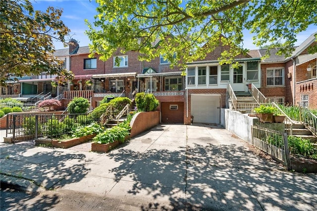 52 E 92nd St, Brooklyn, NY 11212 - multi unit property featuring brick siding, concrete driveway, an attached garage, a garden, and stairway