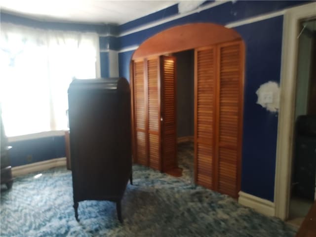324 E 26th St, Brooklyn, NY 11226 - corridor with arched walkways, carpet flooring, and baseboards