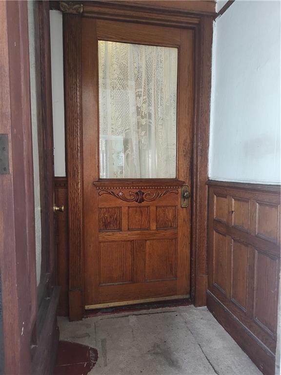 324 E 26th St, Brooklyn, NY 11226 - doorway with a wainscoted wall and concrete floors