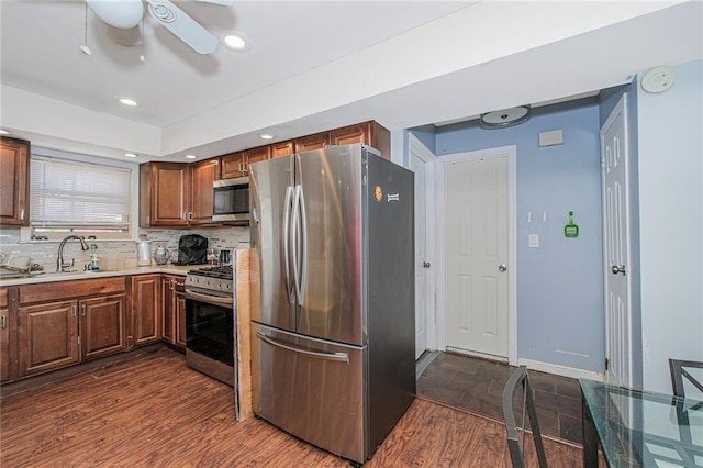 4 Lisa Ln, Staten Island, NY 10312 - kitchen featuring stainless steel appliances, a sink, a ceiling fan, light countertops, and dark wood-type flooring
