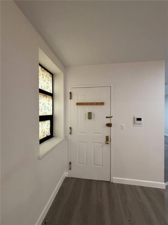 555 W 149th St Unit 4, New York, NY 10031 - doorway featuring dark wood-style flooring and baseboards