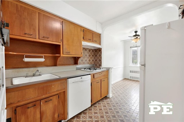 5709 Fillmore Ave, Brooklyn, NY 11234 - kitchen with white appliances, radiator, a sink, backsplash, and a ceiling fan