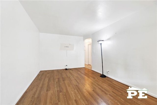 5709 Fillmore Ave, Brooklyn, NY 11234 - unfurnished room featuring wood finished floors, arched walkways, and baseboards