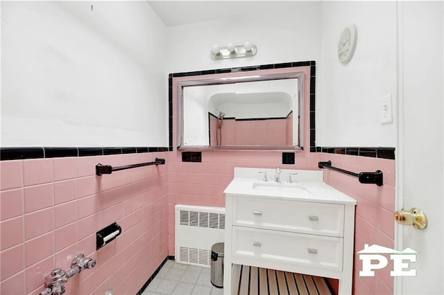 5709 Fillmore Ave, Brooklyn, NY 11234 - bathroom with radiator, tile walls, vanity, and a wainscoted wall