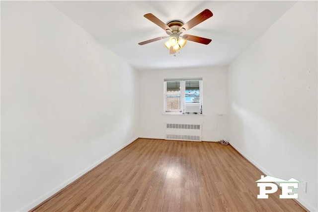 5709 Fillmore Ave, Brooklyn, NY 11234 - empty room featuring radiator heating unit, wood finished floors, a ceiling fan, and baseboards