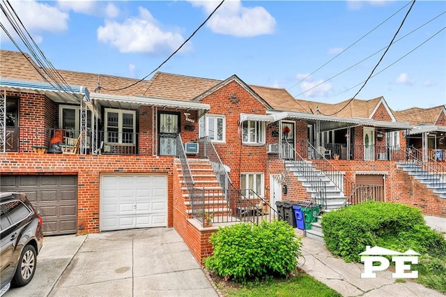 5709 Fillmore Ave, Brooklyn, NY 11234 - view of front of house featuring stairway, brick siding, concrete driveway, and an attached garage