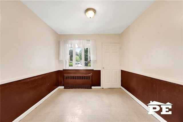 5709 Fillmore Ave, Brooklyn, NY 11234 - unfurnished room featuring radiator and wainscoting