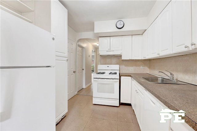 5709 Fillmore Ave, Brooklyn, NY 11234 - kitchen featuring white appliances, under cabinet range hood, a sink, white cabinetry, and tasteful backsplash