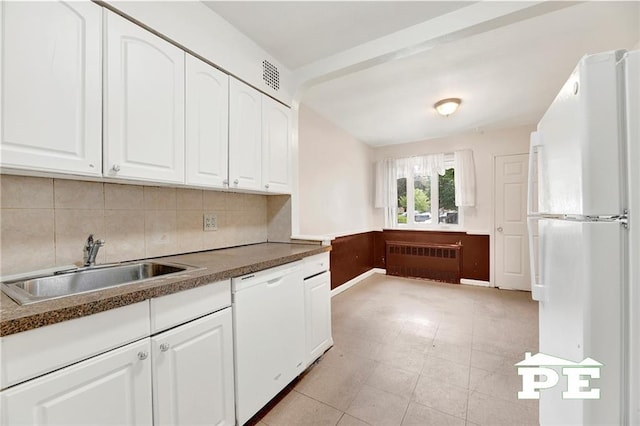 5709 Fillmore Ave, Brooklyn, NY 11234 - kitchen with radiator, white appliances, a sink, white cabinets, and a wainscoted wall