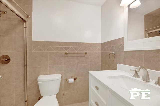 5709 Fillmore Ave, Brooklyn, NY 11234 - bathroom with tile walls, a shower stall, vanity, and toilet