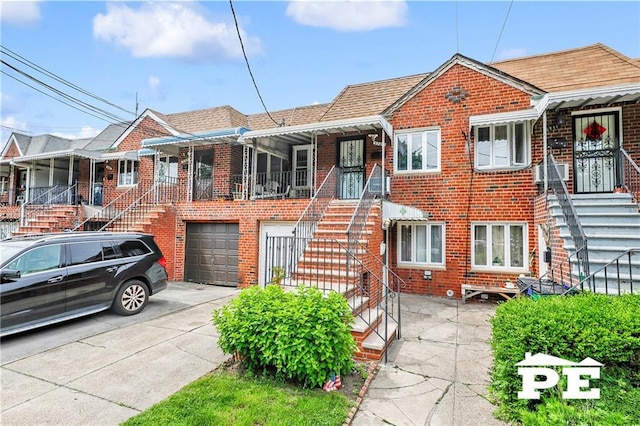 5709 Fillmore Ave, Brooklyn, NY 11234 - view of front of house with concrete driveway, brick siding, stairs, and an attached garage