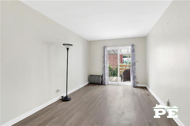 5709 Fillmore Ave, Brooklyn, NY 11234 - empty room featuring radiator, wood finished floors, and baseboards