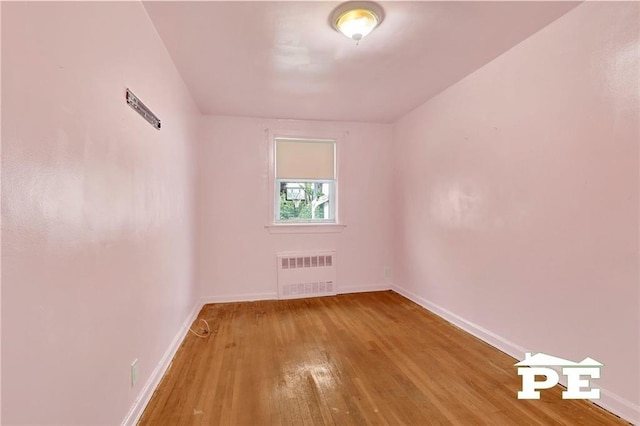 5709 Fillmore Ave, Brooklyn, NY 11234 - spare room with radiator heating unit, hardwood / wood-style flooring, and baseboards