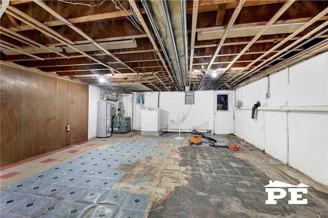 5709 Fillmore Ave, Brooklyn, NY 11234 - unfinished basement with washer / dryer, gas water heater, and wood walls