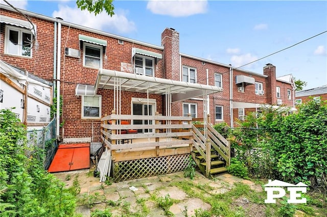 5709 Fillmore Ave, Brooklyn, NY 11234 - rear view of property with brick siding, a wooden deck, and a chimney