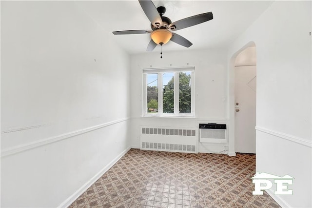 5709 Fillmore Ave, Brooklyn, NY 11234 - empty room with radiator, a ceiling fan, tile patterned floors, and arched walkways