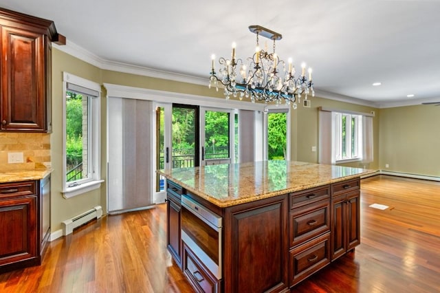 476 Hargold Ave, Staten Island, NY 10309 - kitchen featuring a baseboard radiator, crown molding, wood finished floors, a chandelier, and backsplash