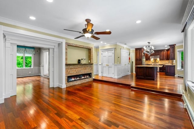 476 Hargold Ave, Staten Island, NY 10309 - unfurnished living room featuring a chandelier, ornamental molding, a baseboard radiator, a ceiling fan, and dark wood-type flooring
