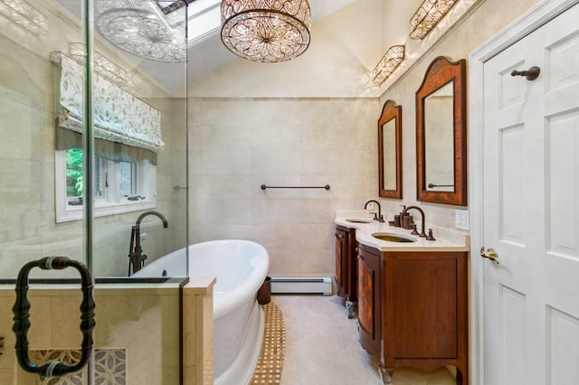 476 Hargold Ave, Staten Island, NY 10309 - full bathroom with baseboard heating, a freestanding bath, double vanity, tile patterned floors, and tile walls