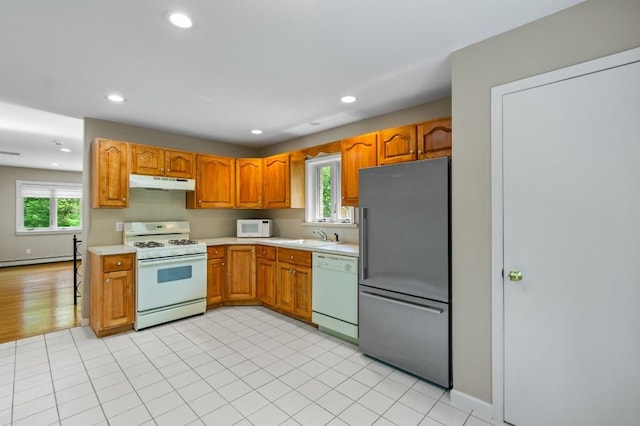 476 Hargold Ave, Staten Island, NY 10309 - kitchen with white appliances, under cabinet range hood, light countertops, baseboard heating, and healthy amount of natural light