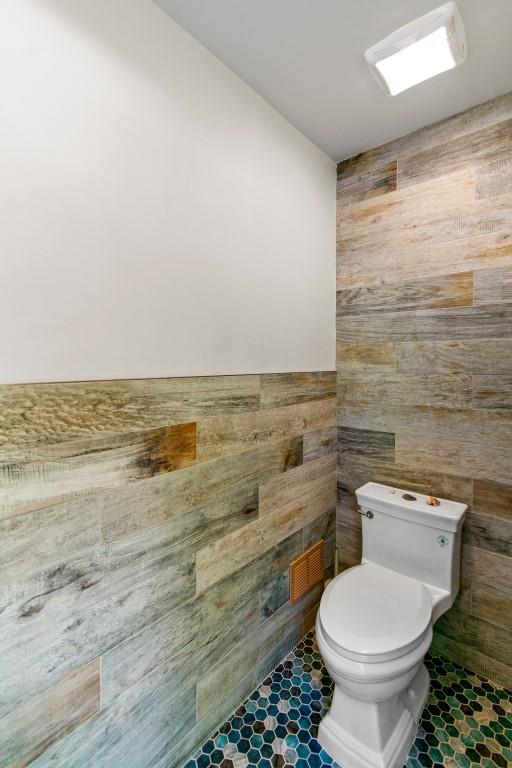 476 Hargold Ave, Staten Island, NY 10309 - bathroom with toilet, wood walls, and a fireplace