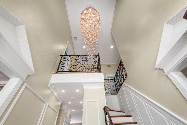 476 Hargold Ave, Staten Island, NY 10309 - stairs with a high ceiling, a decorative wall, a chandelier, wainscoting, and ornamental molding