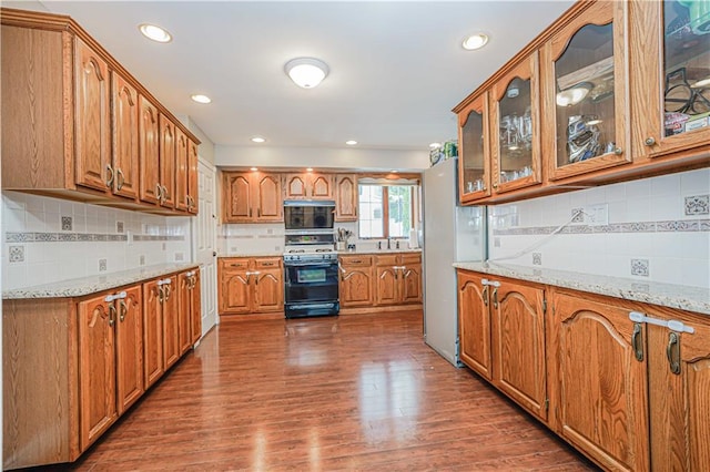 39 Morton St, Staten Island, NY 10306 - kitchen featuring range with gas cooktop, brown cabinetry, tasteful backsplash, wood finished floors, and glass insert cabinets