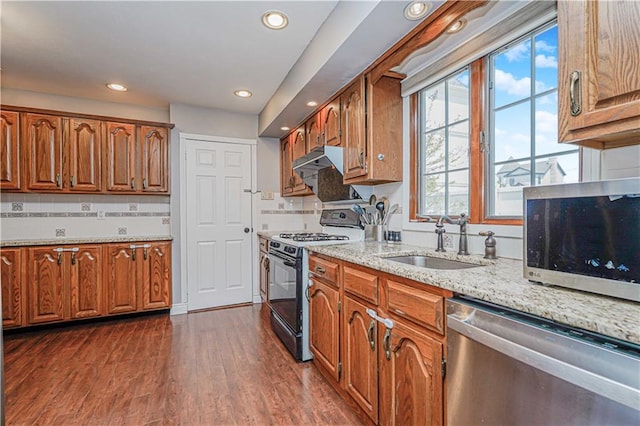 39 Morton St, Staten Island, NY 10306 - kitchen featuring stainless steel appliances, a sink, brown cabinets, light stone counters, and dark wood-style floors